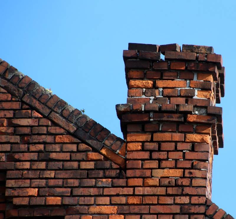 Signs Your Oceanside Home Needs a Chimney Inspection Damaged chimney on an Oceanside home showing cracks and missing mortar